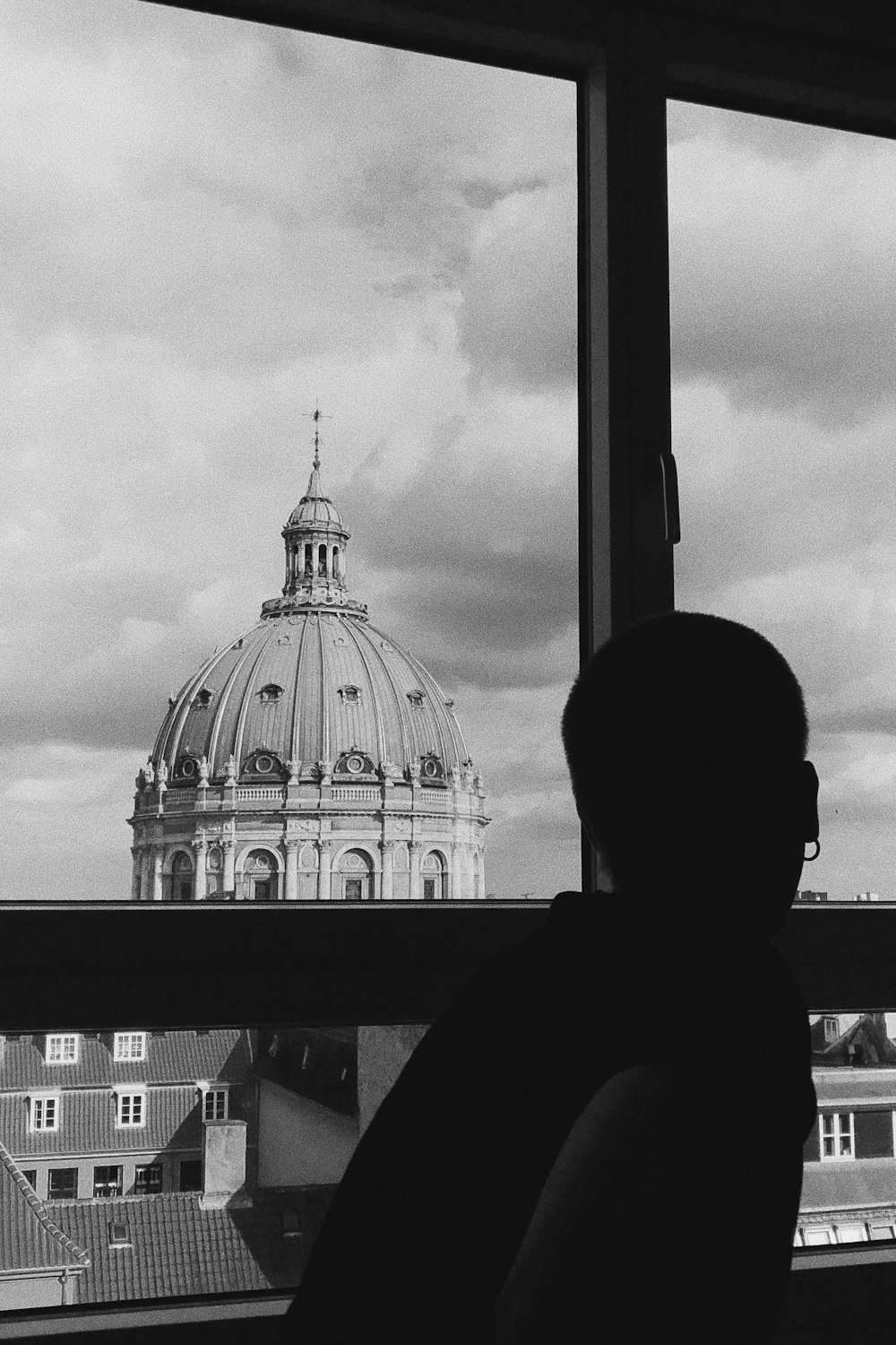 silhouette of man standing near building
