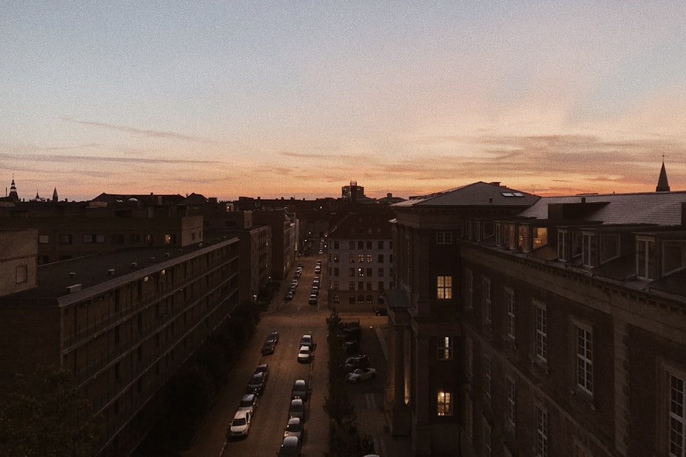 cars parked on the side of the road during sunset