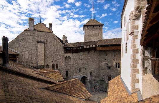 gray concrete building under blue sky during daytime in Château de Chillon Switzerland