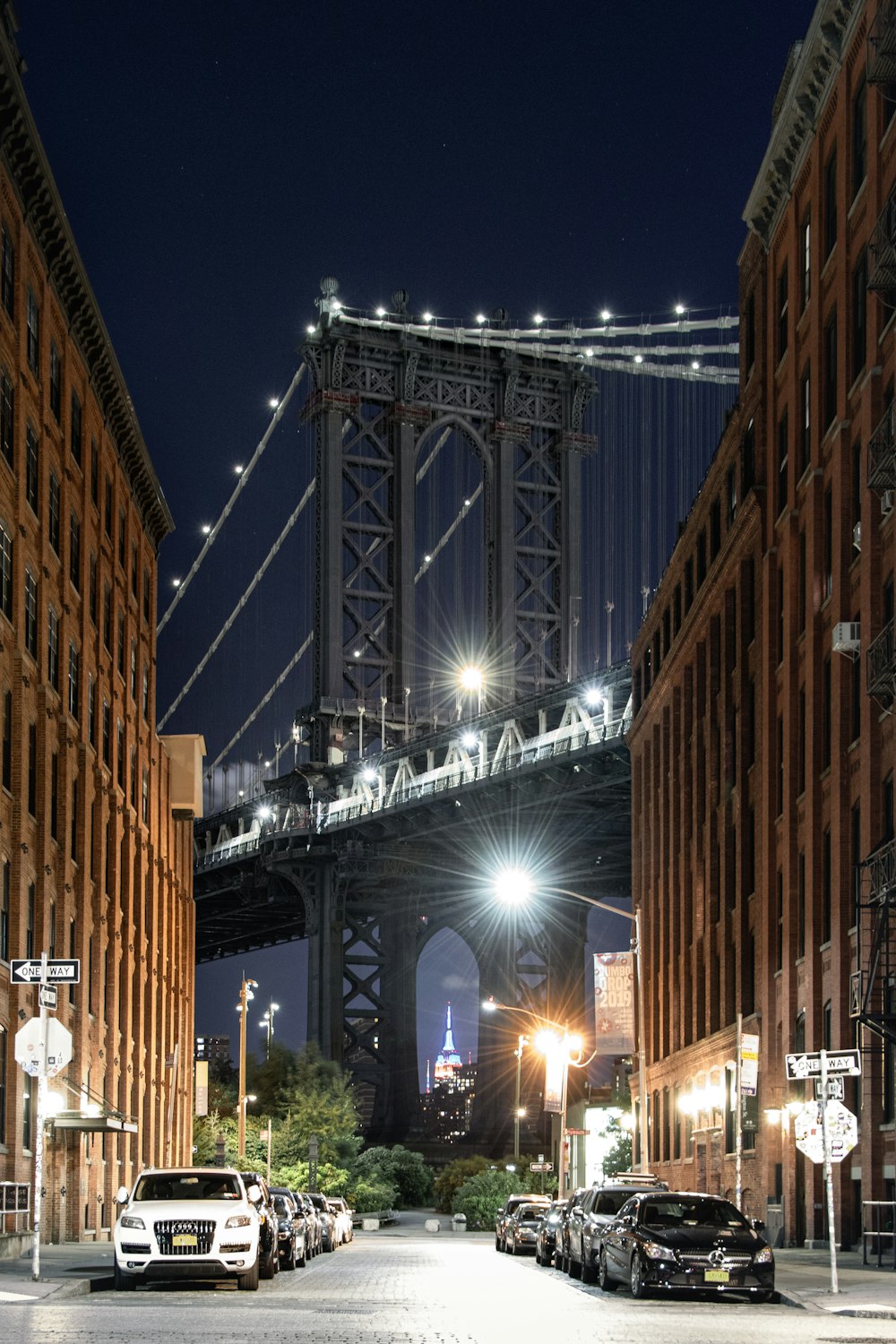 people walking on sidewalk near brown concrete building during night time