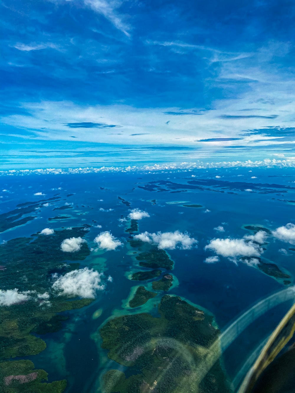 blue and white clouds over blue sea