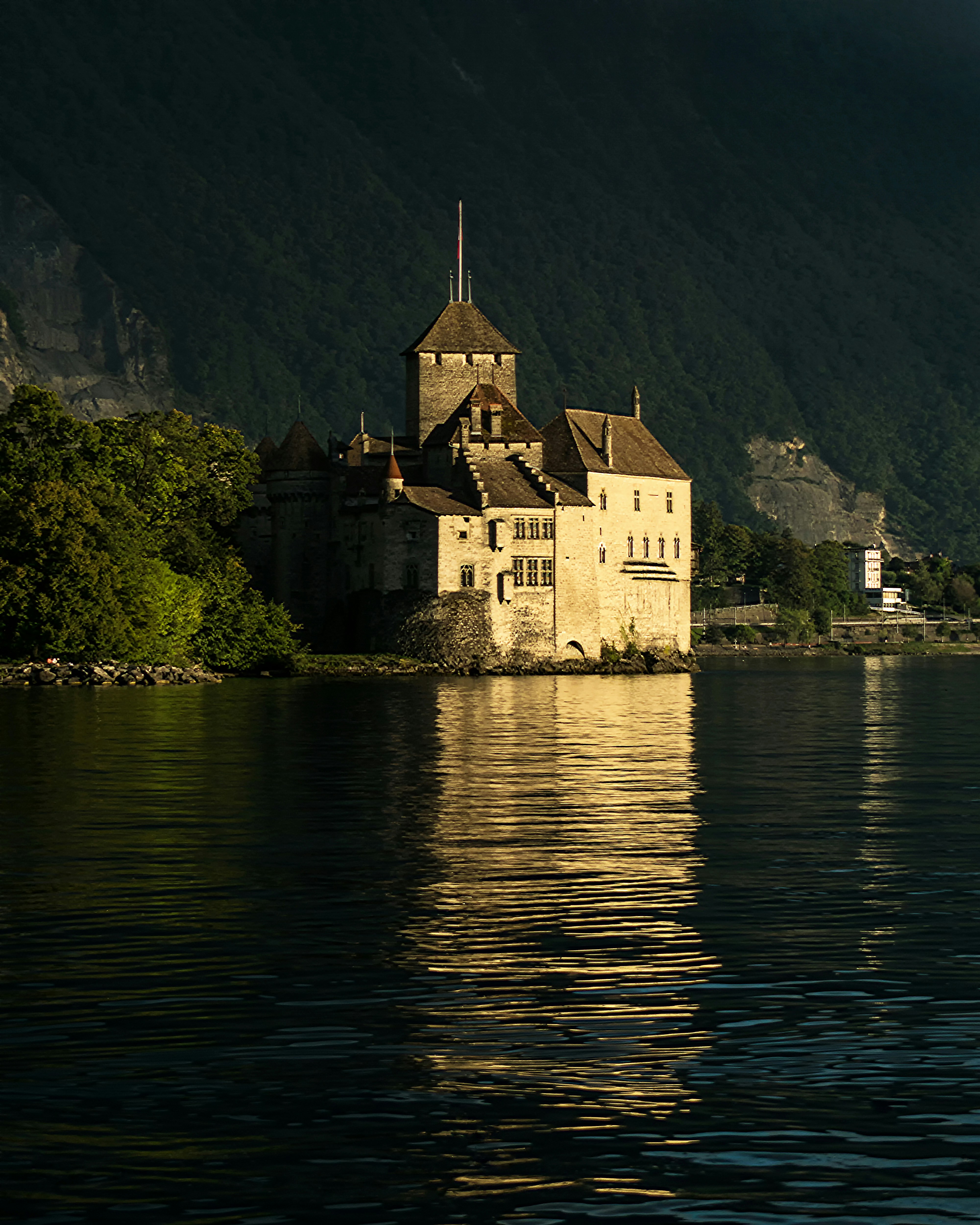 brown concrete building near body of water during daytime