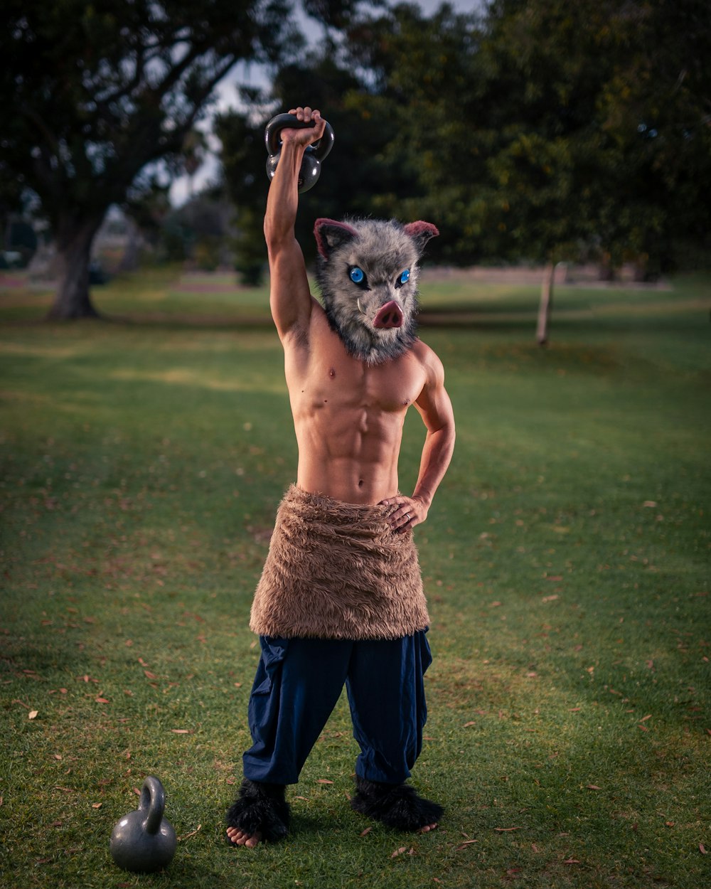 topless man in blue denim jeans holding black and brown short coated dog