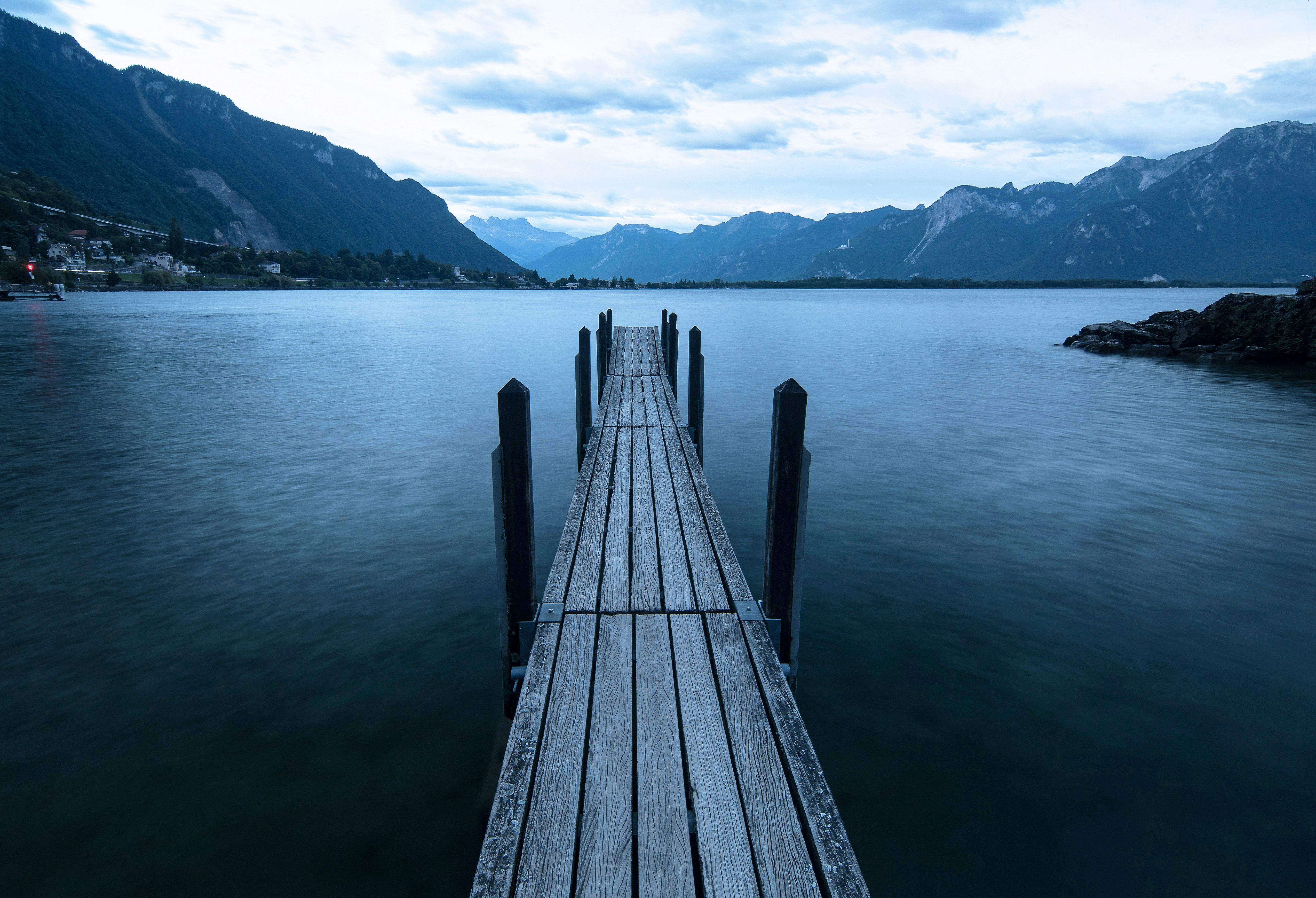 brown wooden dock on lake during daytime