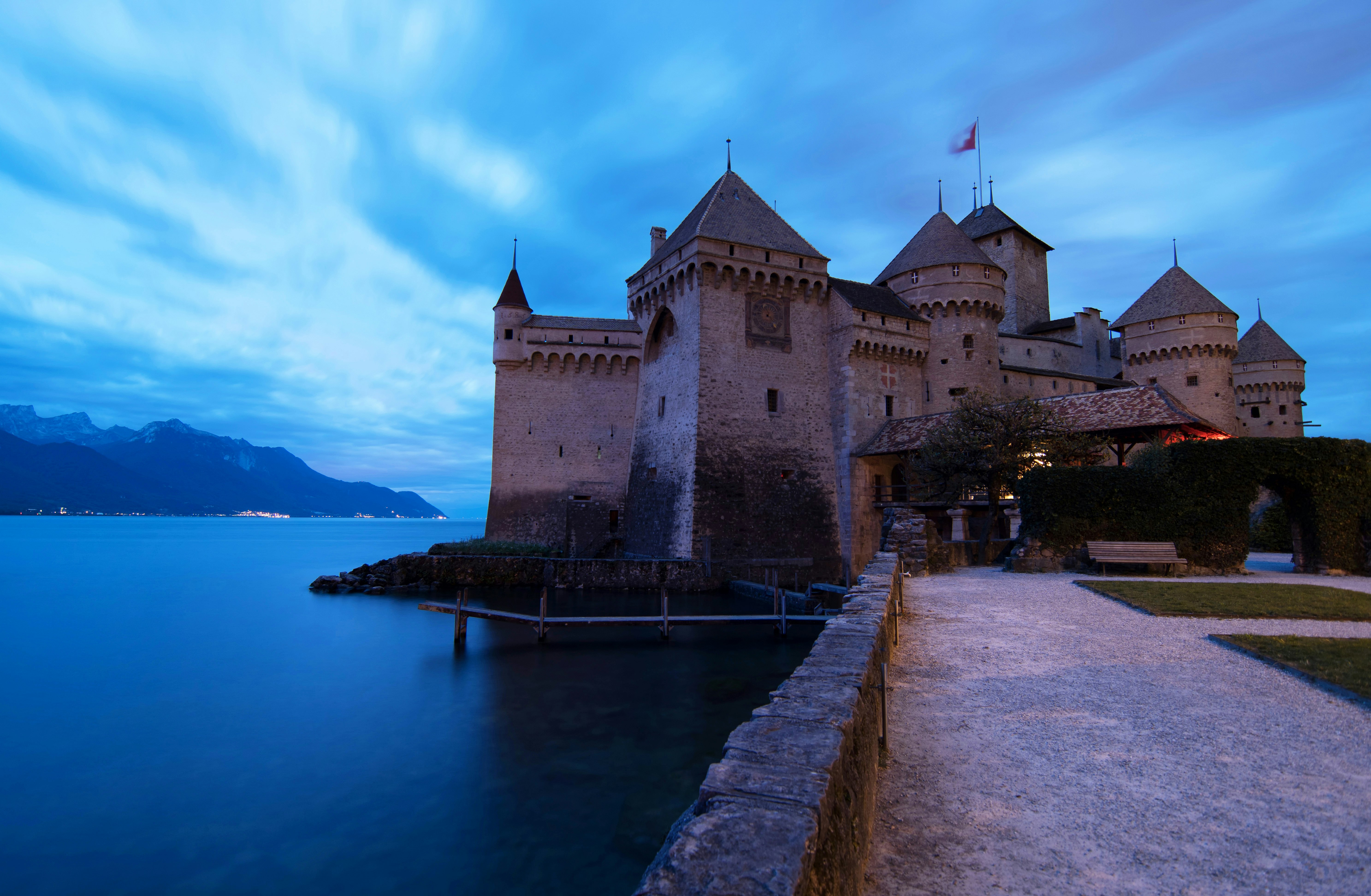 gray concrete castle near body of water during daytime