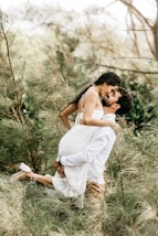 woman in white dress holding her face