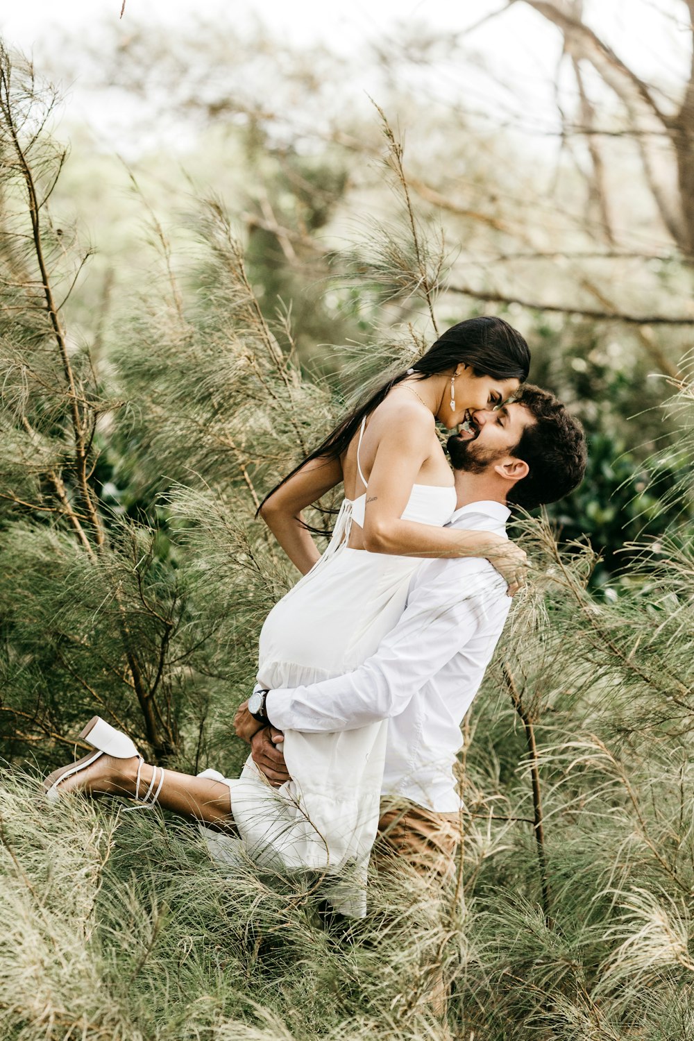 woman in white dress holding her face