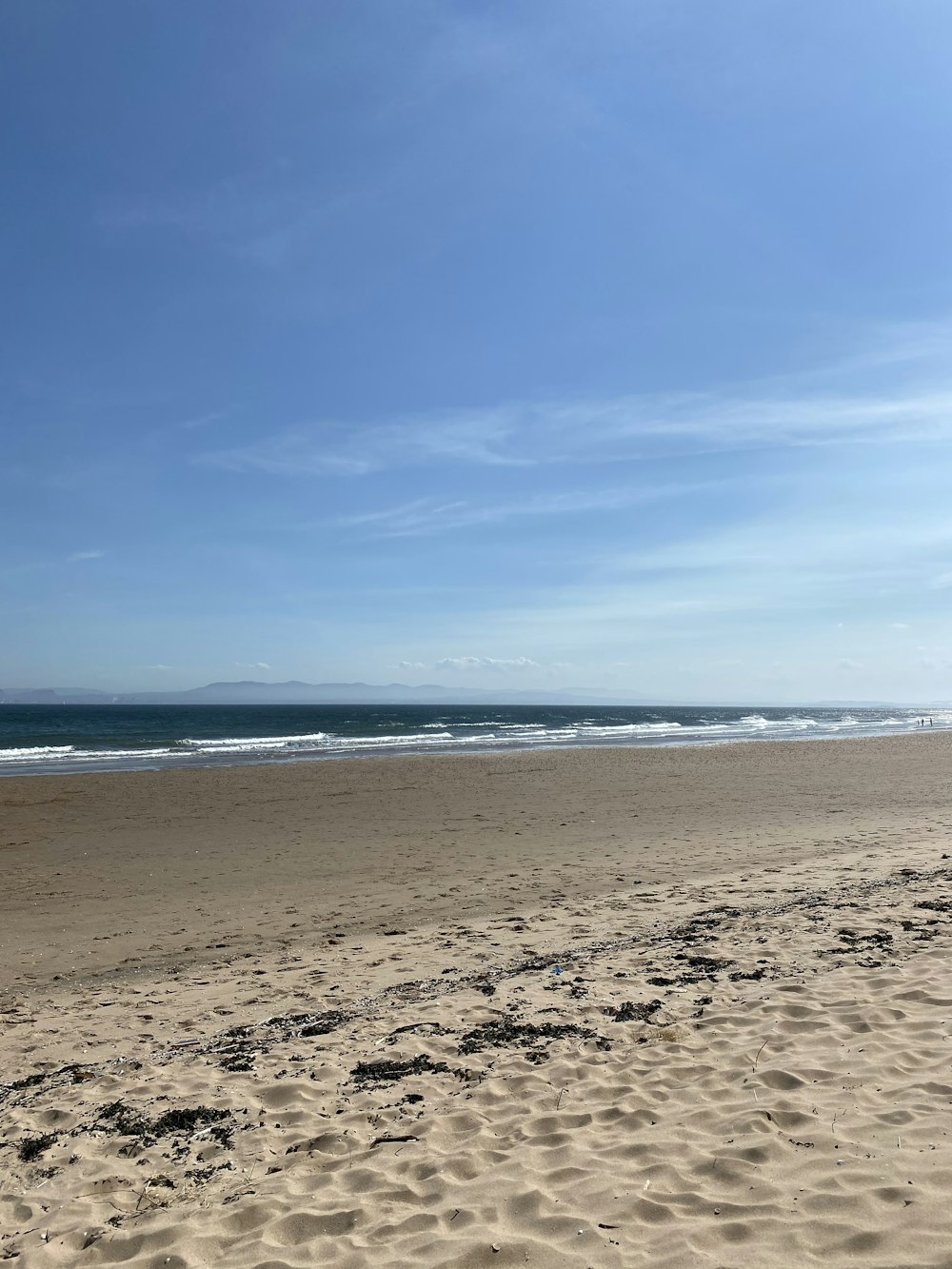 brown sand near body of water during daytime