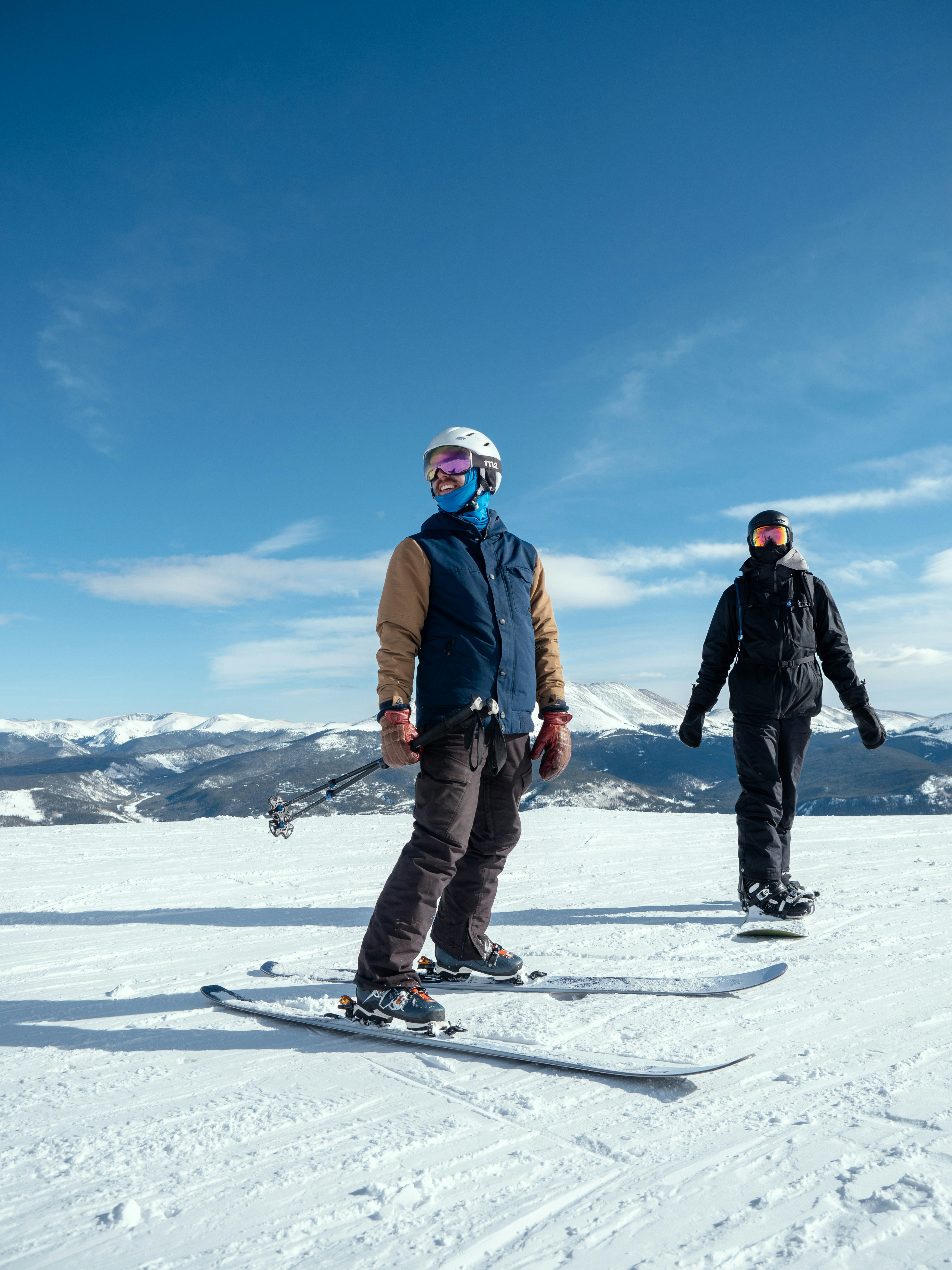 man in blue jacket and black pants riding on snowboard during daytime