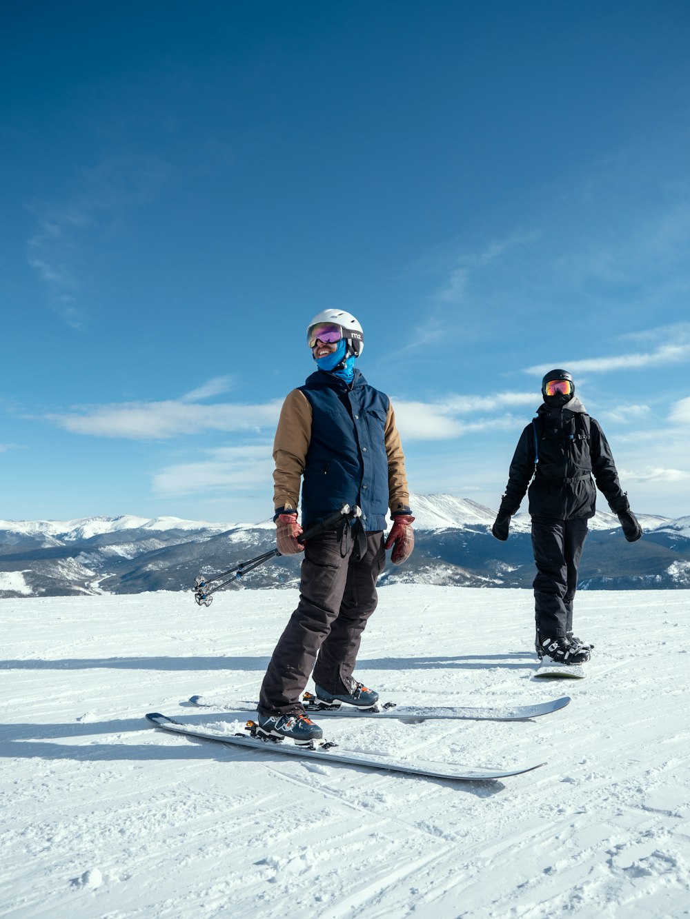 man in blue jacket and black pants riding on snowboard during daytime