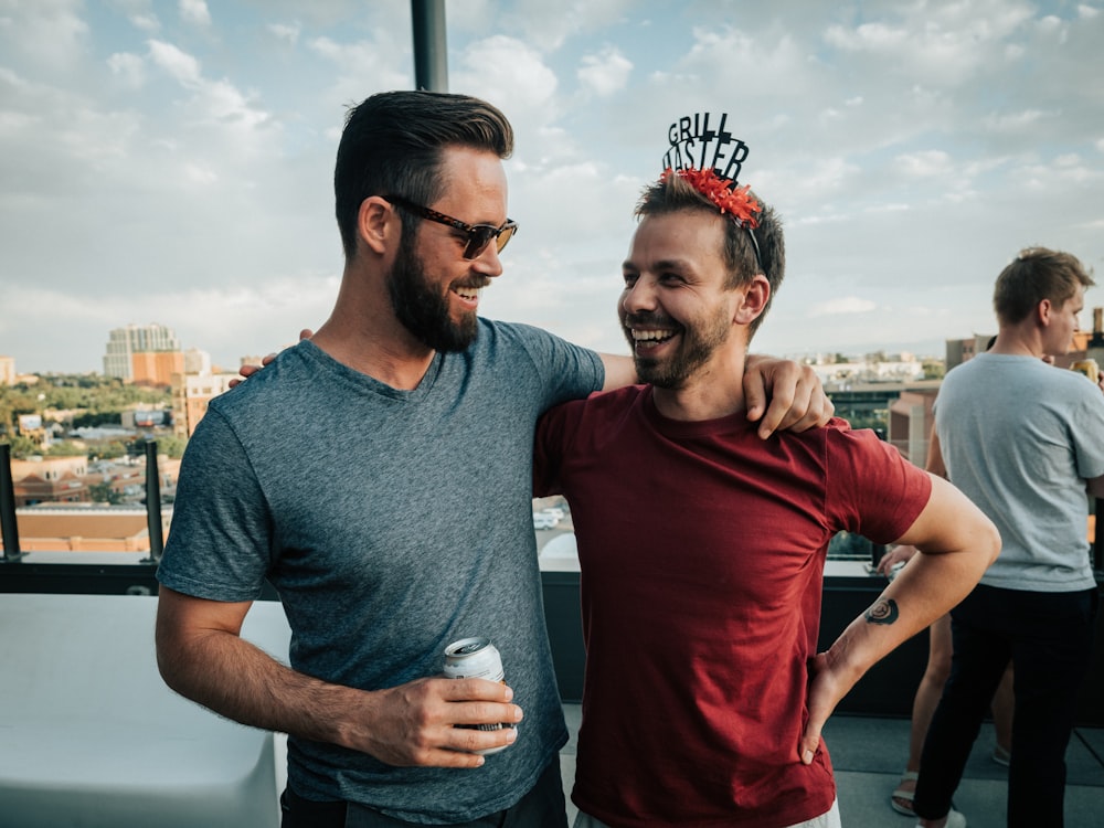 man in gray crew neck t-shirt standing beside man in red crew neck t-shirt