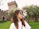 Smiling woman standing in front of a medieval castle in Southern Transylvania