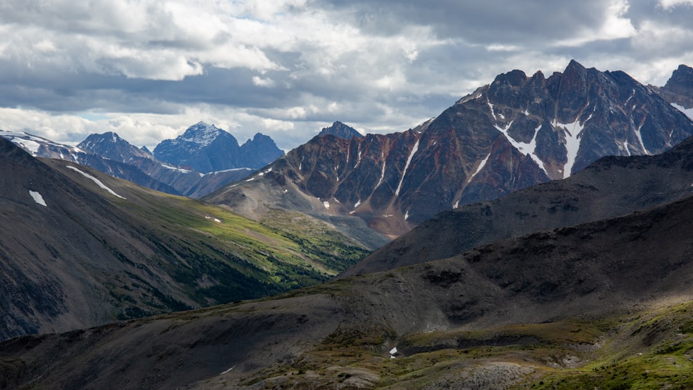 green and brown mountains under white clouds during daytime