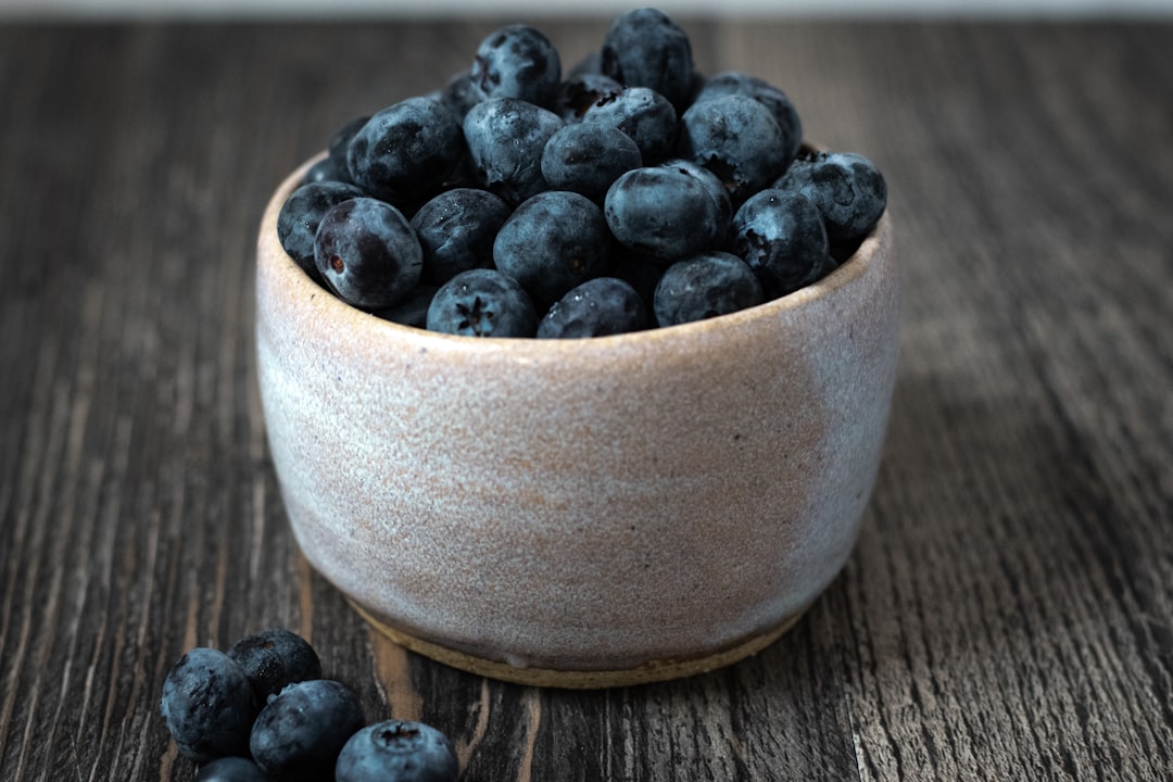 black berries in brown ceramic bowl