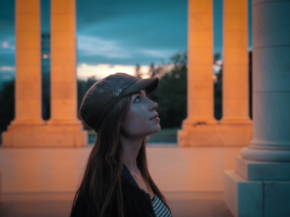 woman in black hat and black and white striped shirt