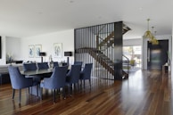 Open-concept dining area with modern lighting and hardwood floors.