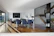A bright dining area showcasing a solid wood tech evolve dining table with blue accents.