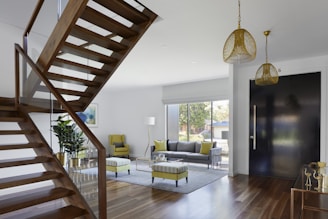 brown wooden spiral staircase near gray couch