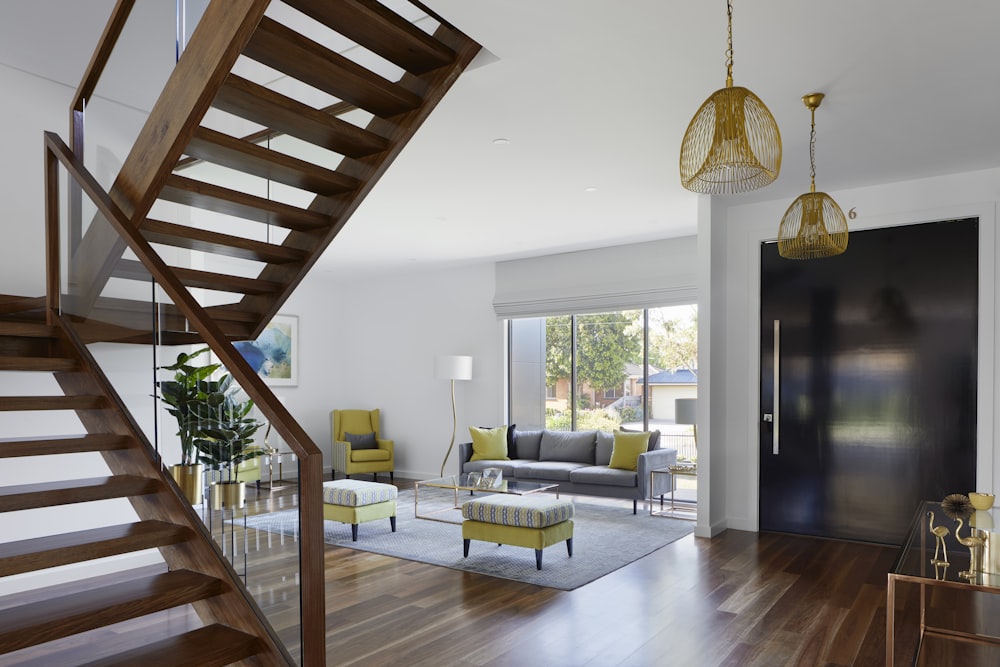 brown wooden spiral staircase near gray couch