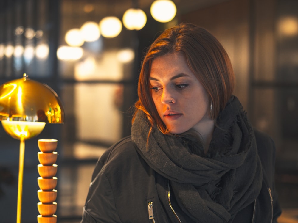 woman in black hoodie looking at the light