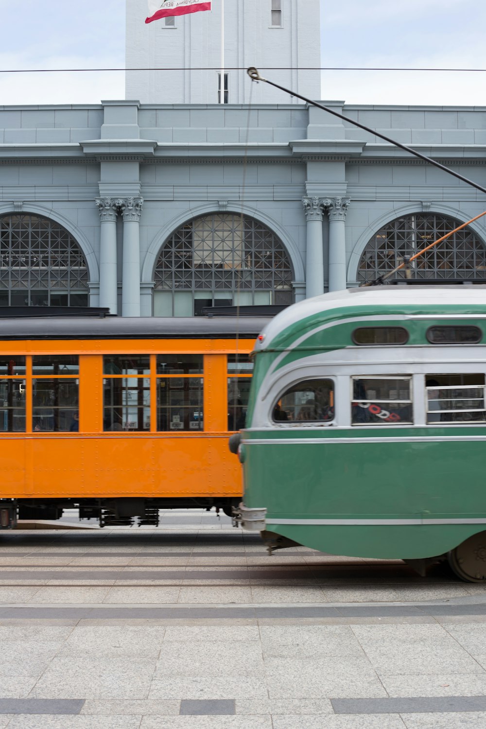 green and yellow train on rail road during daytime