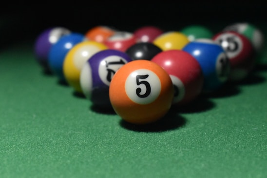 Close-up of colorful rating balls arranged in a pattern on a wooden table.