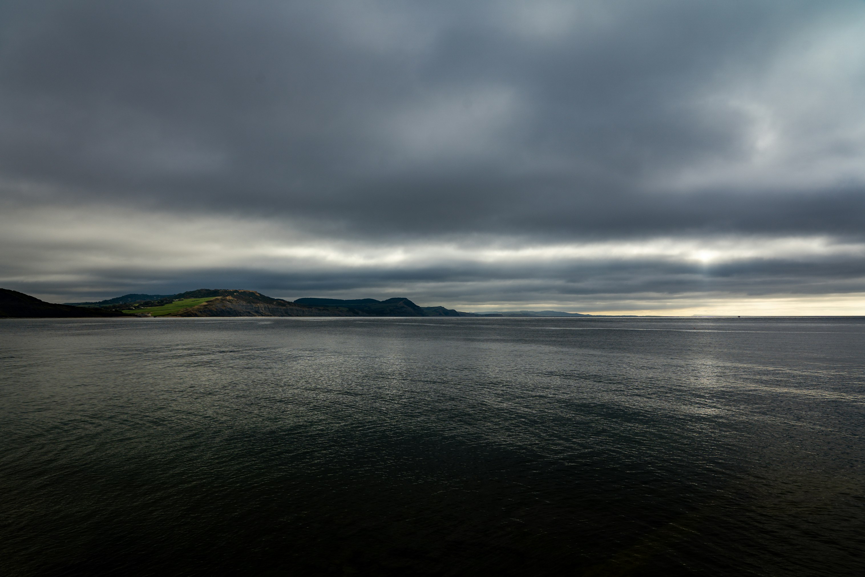 body of water under cloudy sky during daytime