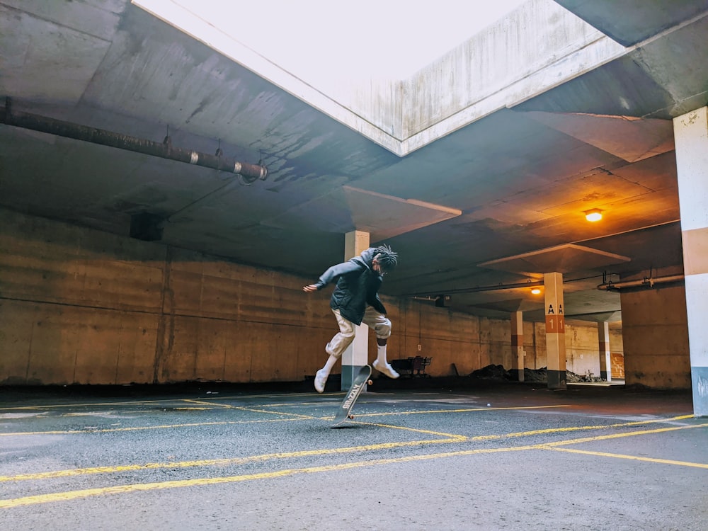 man in black jacket and black pants wearing black backpack walking on gray asphalt road during