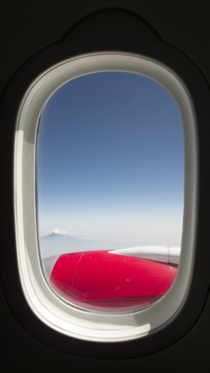 white and red airplane wing during daytime