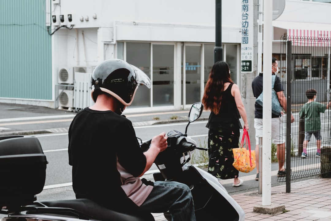 woman in black long sleeve shirt riding on black motorcycle during daytime