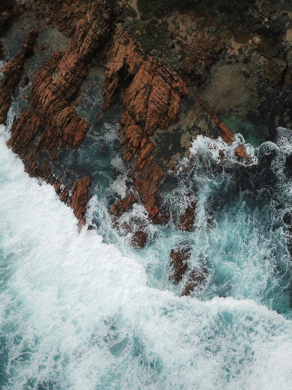 water waves hitting brown rock