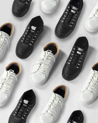 Elegant women's sneakers arranged on a clean white surface with black and gray details.