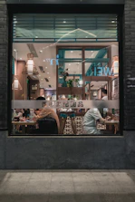 Cozy restaurant interior with warm lighting and happy diners enjoying meals.