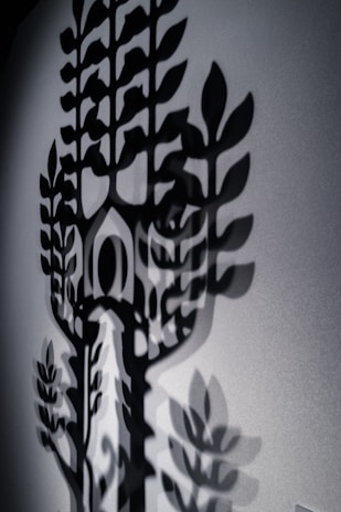 An artistic shot of shadows shaped like a brain cast by wild branches.