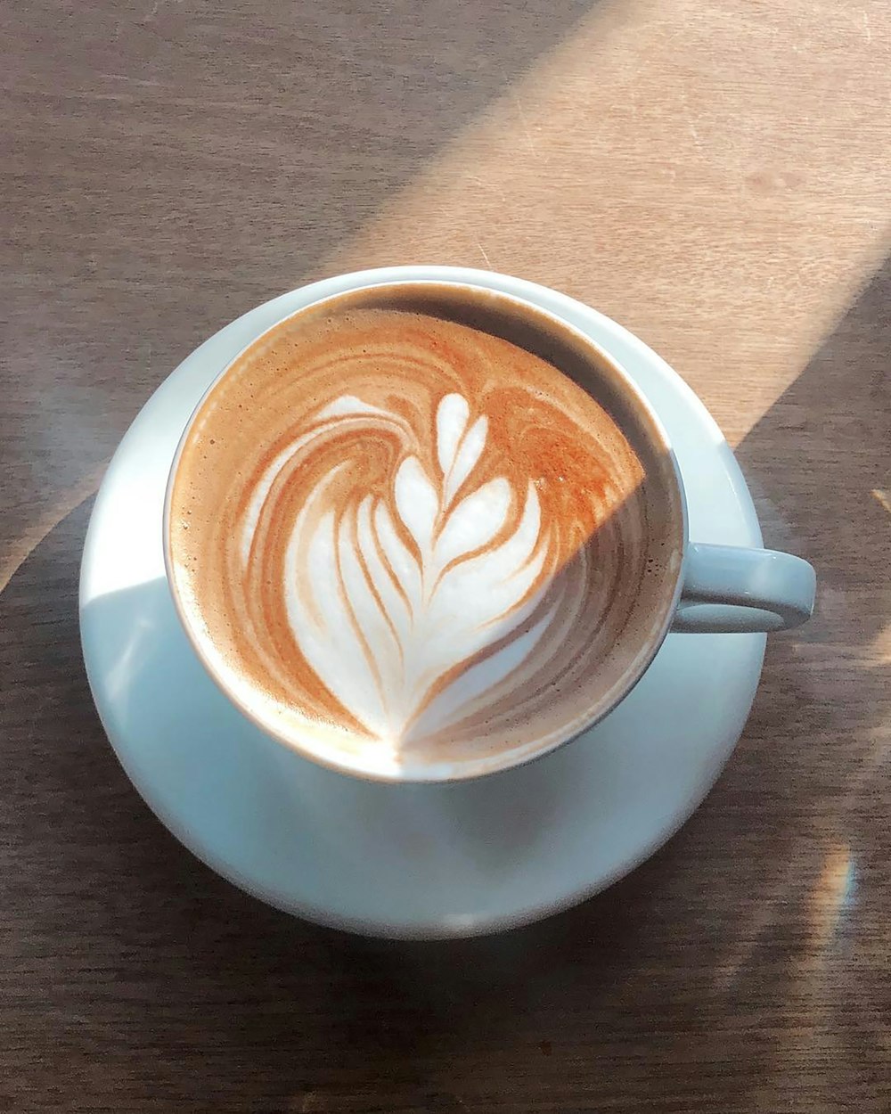 white ceramic cup with brown and white liquid