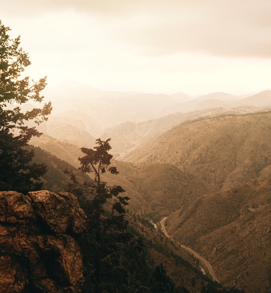 person standing on rock formation during daytime in Golden United States