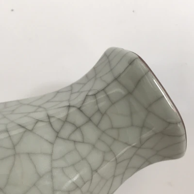 Close-up of a ceramic decorative ornament with intricate patterns and a glossy finish.