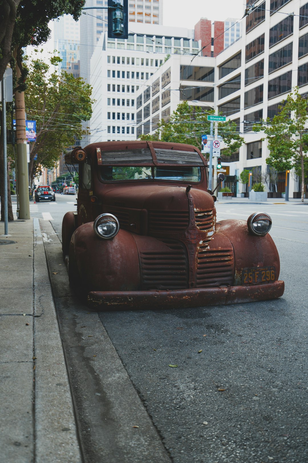 red vintage car on gray asphalt road during daytime