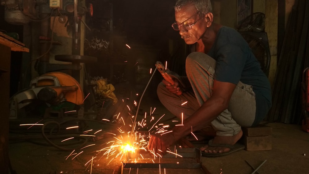 man in gray t-shirt holding sparkler