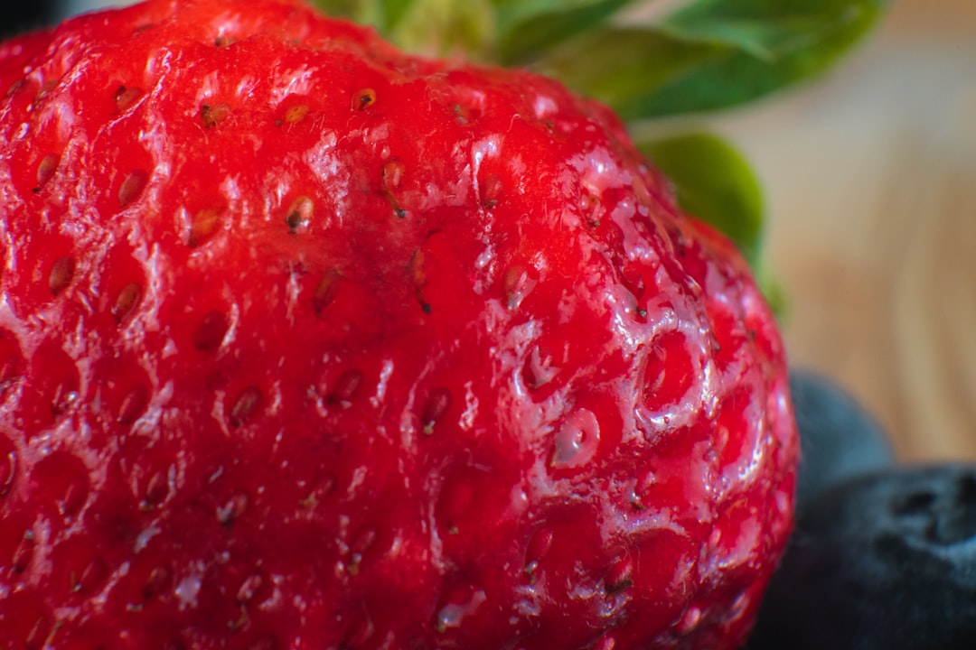 red strawberry fruit in close up photography