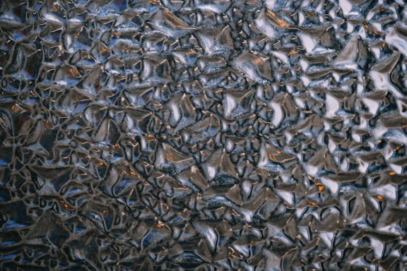 A close-up of a professional window film sample showing texture and color variations.