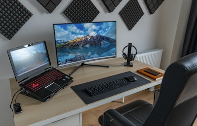 black and silver laptop computer on brown wooden table
