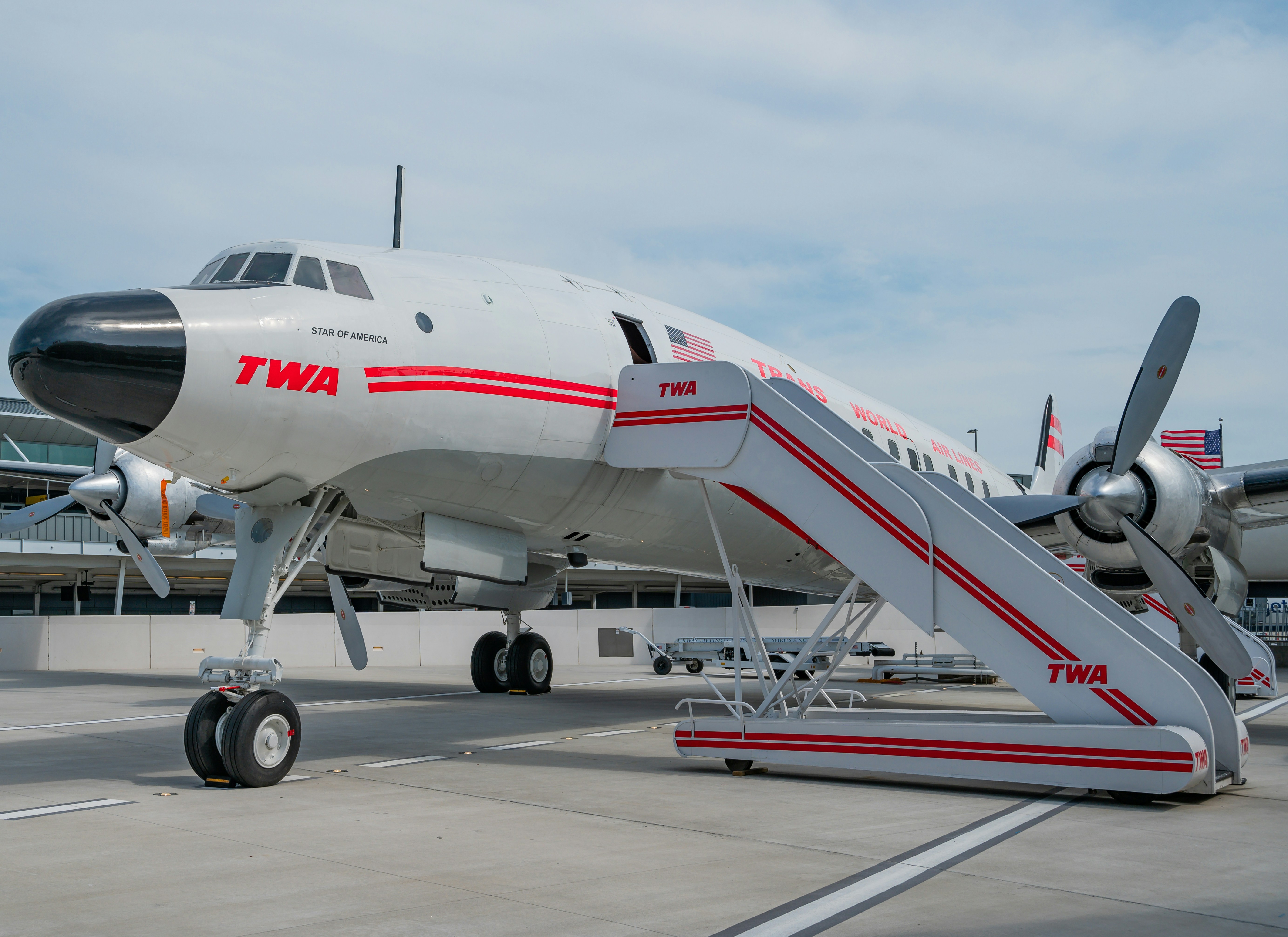 white and red passenger plane on airport during daytime, Vintage 1958 Lockheed Constellation on the runway at the TWA hotel..