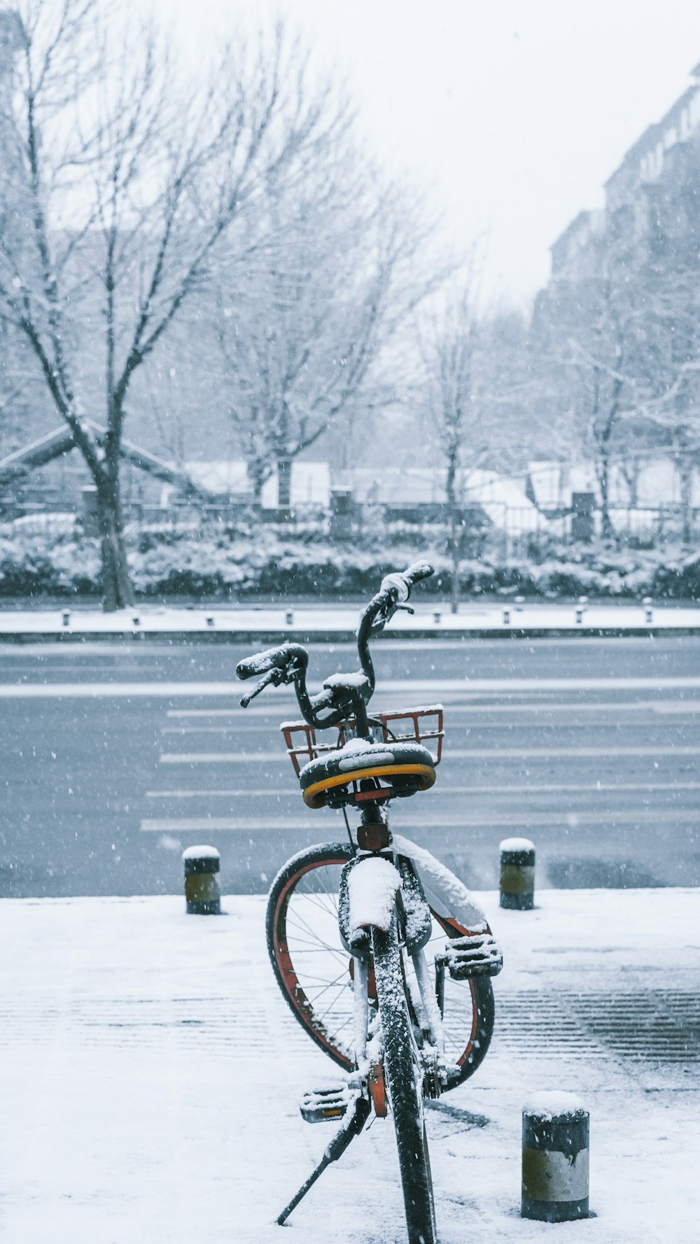 man riding bicycle on snow covered ground during daytime