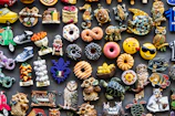 A set of colorful PVC fridge magnets arranged neatly on a white surface.