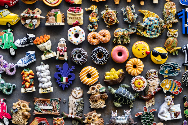 A collection of colorful custom magnets arranged artistically on a wooden surface.