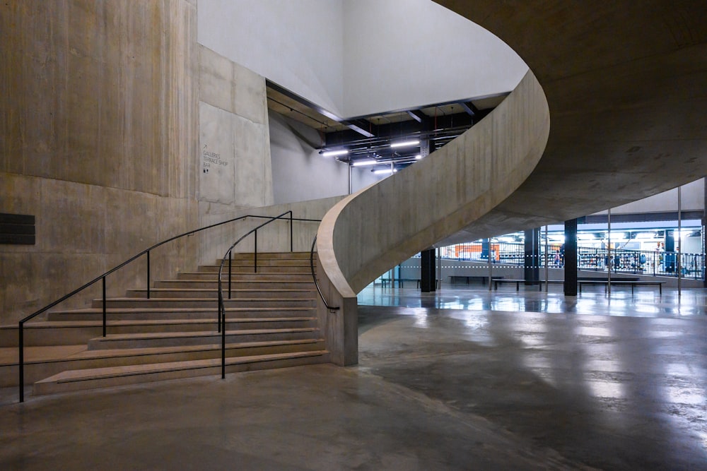 white concrete building with gray metal staircase