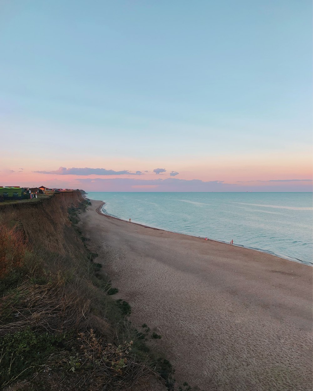 brown sand beach during sunset