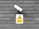 A CCTV surveillance camera is mounted on a gray brick wall. Below the camera is a yellow warning sign indicating that CCTV is in operation with an image of a camera in a triangular warning symbol.