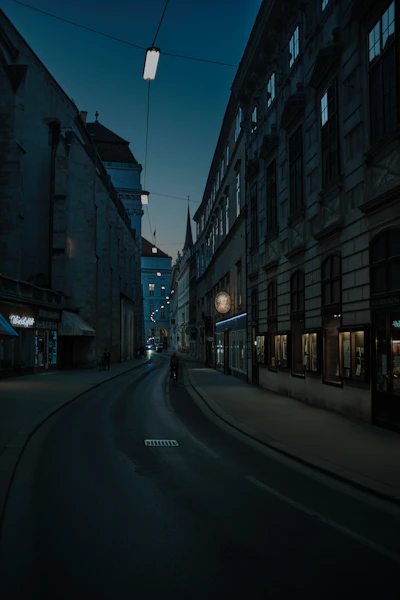 empty road between high rise buildings during night time